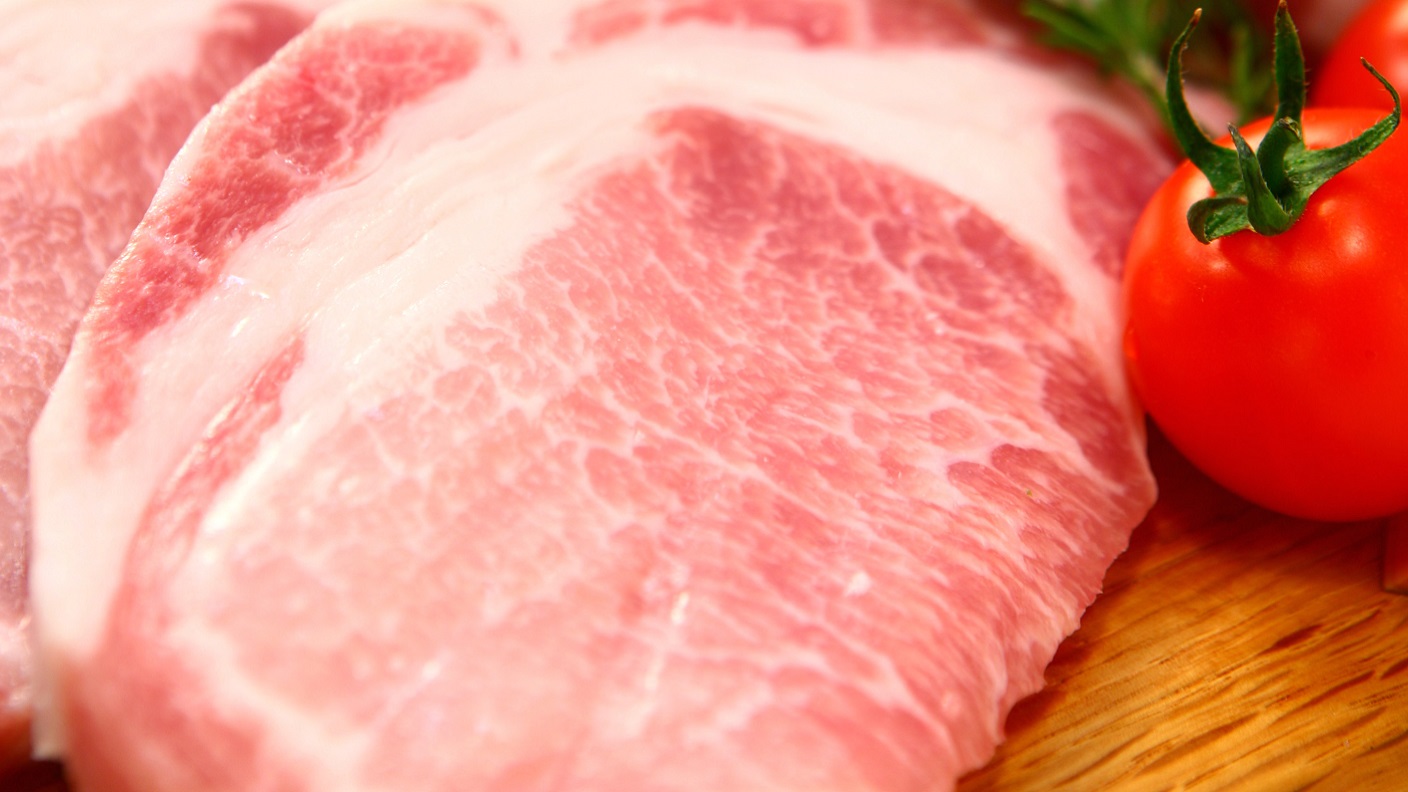 Pork cuts and a tomato